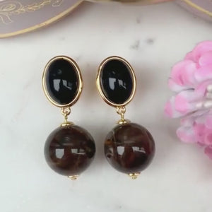 Stilvolle Kugel-Ohrclips in Schwarz und Braun